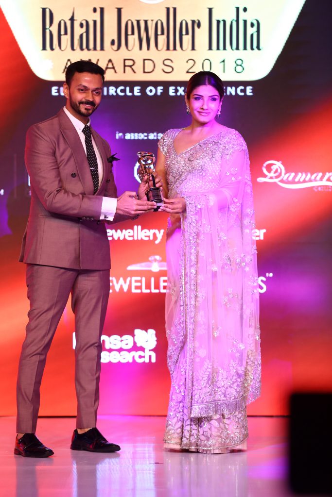 Gautam Soni-Managing Director, The House of MBj receiving award for the Innovative Jewellery of the Year from actress Raveena Tandon at Retail Jeweler Awards 2018